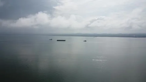 Aerial view of a tugboat towing an empty barge in the Kalimantan sea Stock Footage 267525831