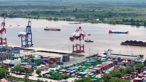 Aerial view of tugboats pulling coal-laden barges near the port Stock Footage 336079808