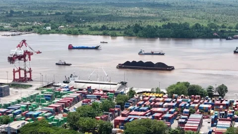 Aerial view of tugboats pulling coal-laden barges near the port Stock Footage 336088517