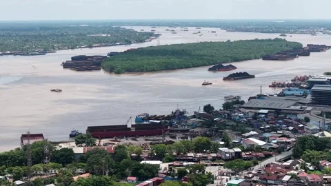 Aerial view of tugboats pulling coal-laden barges near the port Stock Footage 336089239