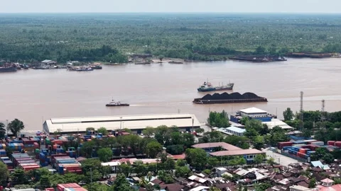 Aerial view of tugboats pulling coal-laden barges near the port Stock Footage 336089567