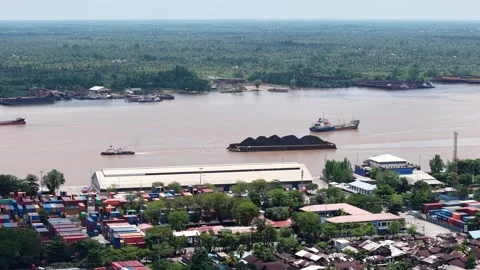 Aerial view of tugboats pulling coal-laden barges near the port Video stock 336089749