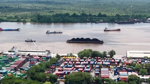 Aerial view of tugboats pulling coal-laden barges near the port Stock Footage 336090106