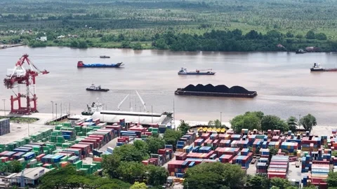 Aerial view of tugboats pulling coal-laden barges near the port Stock Footage 336090113
