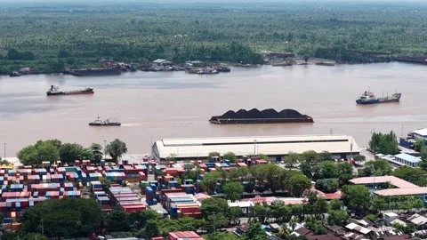 Aerial view of tugboats pulling coal-laden barges near the port Video stock 336090831