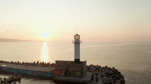 Aerial view turn a drone lighthouse in the seaport against a smooth sea surface Stock Footage 119212155