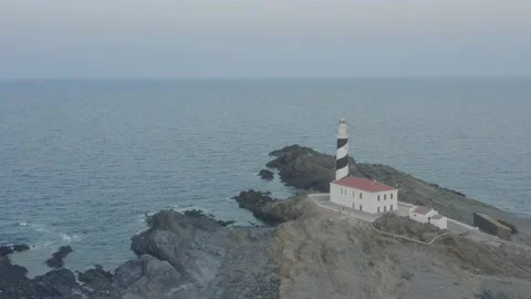 Aerial View Turning 360 Degrees Showing A Lighthouse At Sunset Stock Footage 136560044