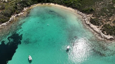 Aerial view of turquoise bay with sandy beach and rocky coastline, Halkidiki Stock Footage 327724341
