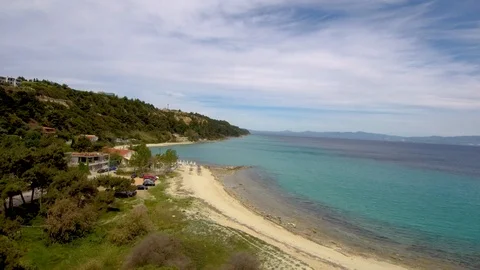 Aerial view of turquoise beach under a tourist village, Athitos Halkidiki Greece Stock Footage 112711142