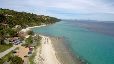 Aerial view of turquoise beach under a tourist village, Athitos Halkidiki Greece Stock Footage 112712522