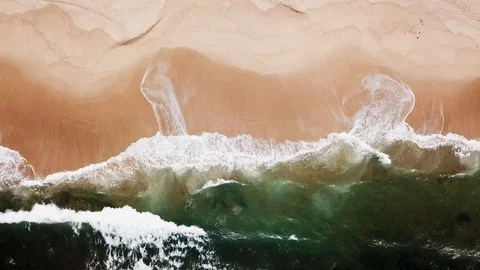 Aerial view on turquoise huge waves with white foam which covers empty beach Stock Footage 118937985
