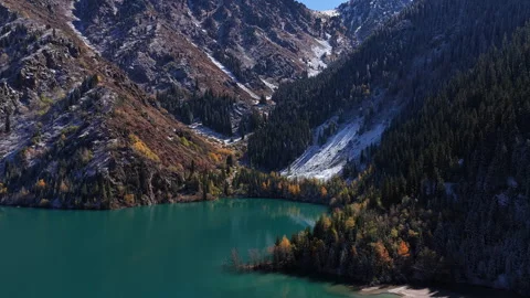 Aerial view of turquoise mountain Issyk's lake and autumn forest, Kazakhstan Stockbeeldmateriaal 344100636