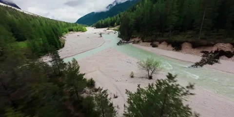 Aerial view of a turquoise mountain river flowing through a scenic valley . Stockbeeldmateriaal 344086378