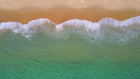 Aerial view of turquoise ocean wave reaching the coastline 스톡 동영상 170823830