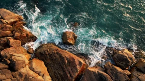Aerial View of the Turquoise Ocean Waves Crash Against Rocky Coastline, moody Stock Footage 283656238