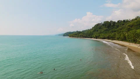 Aerial view of turquoise ocean waves meeting tropical forest in Costa Rica Video stock 327454995