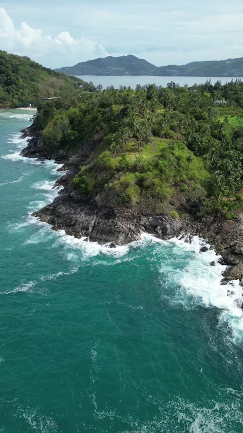 Aerial View of Turquoise Ocean Waves Crashing on Rocky Coastline in Phuket, Stock Footage 335583530