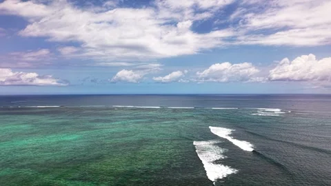 Aerial view of turquoise ocean waves and blue sky with clouds Stock Footage 337827422