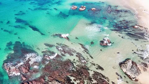 Aerial View of Turquoise Ocean Waves Crashing on Rocky Shoreline Stock Footage 340245188