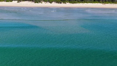 Aerial View of Turquoise Ocean Waves Rolling Toward Sandy Beach Stock Footage 342231300
