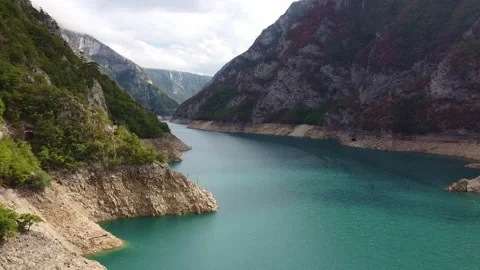 Aerial view of turquoise river winding through steep mountain gorge in Stock-Footage 342775306