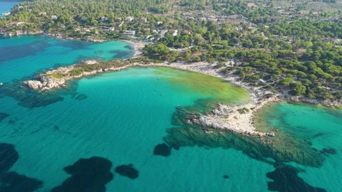 Aerial view of the turquoise waters and sandy shoreline of Karydi Beach, located Stock Footage 346690573