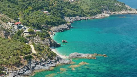 Aerial view of the turquoise waters and rocky coastline of Milopotamos Beach in Stock Footage 346704872