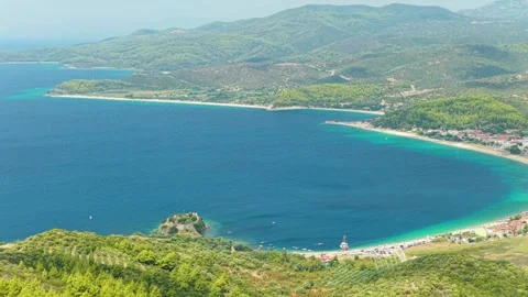 Aerial view of the turquoise waters and sweeping bay of Toroni, a coastal Stock Footage 346714541