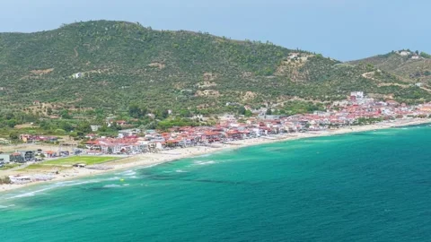 Aerial view of the turquoise waters and sandy coastline of Sarti, a seaside Stock Footage 346715264