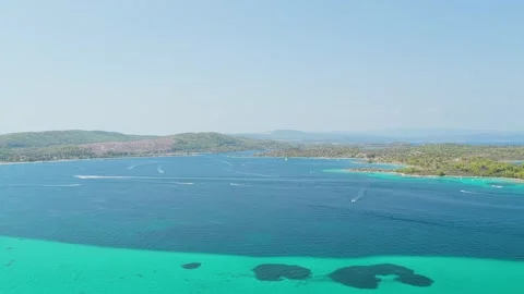 Aerial view of the turquoise waters and lush green coastline of Diaporos Island Stock Footage 346722778
