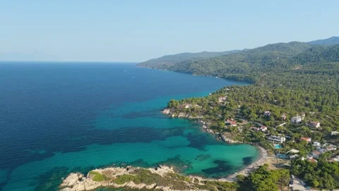 Aerial view of the turquoise waters, sandy coves, and lush green pine forests Stock Footage 346690426