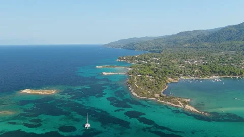 Aerial view of the turquoise waters, sandy beaches, and lush green coastline of Stock Footage 346703518