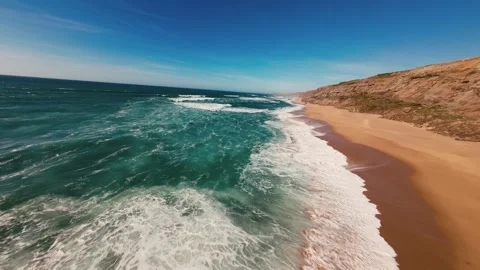 Aerial view of turquoise waves crashing on golden sand Stock Footage 341821090