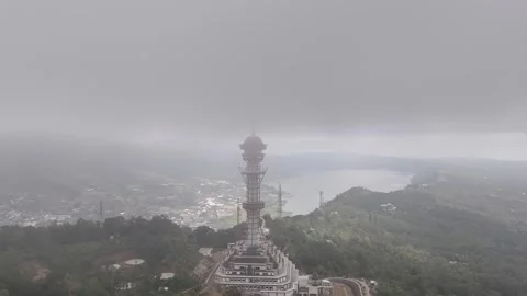 Aerial view of the Turyapada Tower surrounded by mist and clouds Stock Footage 316145168