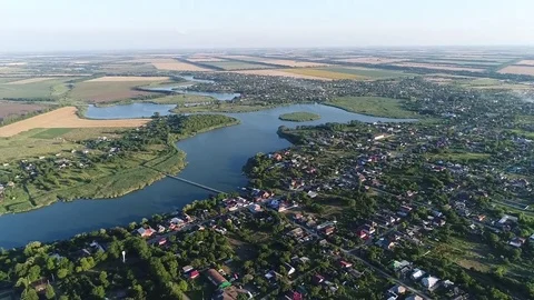 Aerial View. Twisting River Flows On The Plain Between Fields And Villages Video stock 77734543