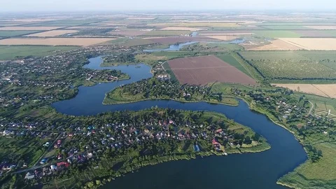 Aerial View. Twisting River Flows On The Plain Between Fields And Villages Video stock 77735369
