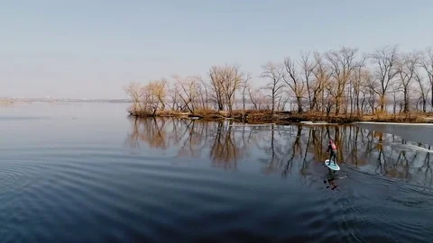 Aerial view of two athletes on the SUP. Winter. Ice. Stock Footage 73296268