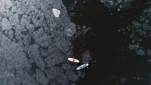 Aerial view of two athletes on the SUP. Winter. Ice. Stock Footage 73296480