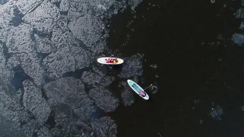 Aerial view of two athletes on the SUP. Winter. Ice. Stock Footage 73296550