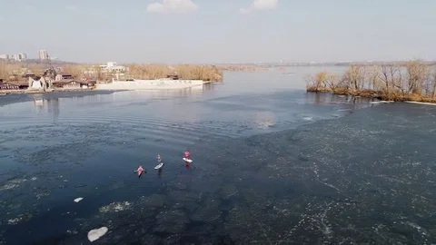 Aerial view of two athletes on the SUP and kayaker. Winter. Ice. Stock Footage 73296635