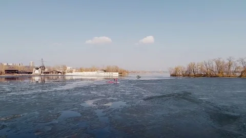 Aerial view of two athletes on the SUP. Winter. Ice. Slowmotion. Stock Footage 73298655