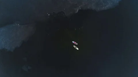 Aerial view of two athletes on the SUP. Winter. Ice. Stock Footage 73590102