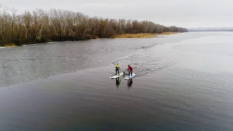 Aerial view of two athletes on the SUP. Winter. Ice. Stock Footage 73591081