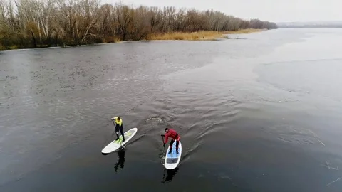 Aerial view of two athletes on the SUP. Winter. Ice. Stock Footage 73591344
