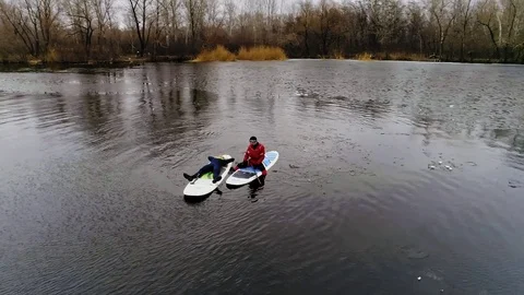 Aerial view of two athletes on the SUP. Winter. Ice. Stock Footage 73592057
