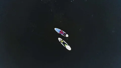 Aerial view of two athletes on the SUP. Winter. Ice. Stock Footage 73592261
