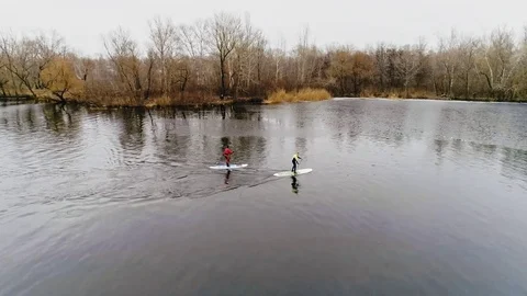 Aerial view of two athletes on the SUP. Winter. Ice. Stock Footage 73592909