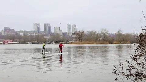 Aerial view of two athletes on the SUP. Winter. Ice. Stock Footage 73593610