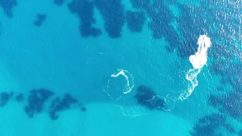 Aerial view of two boat floating across the vibrant blue sea, creating Видео 341126604