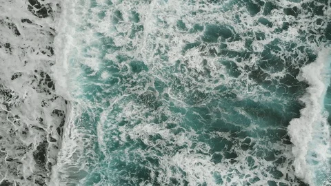 Aerial view. Two bodiserfer trying to swim through the giant waves. Cinematic Stock Footage 112033126